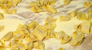 handmade agnolotti dal plin on tray ready to cook